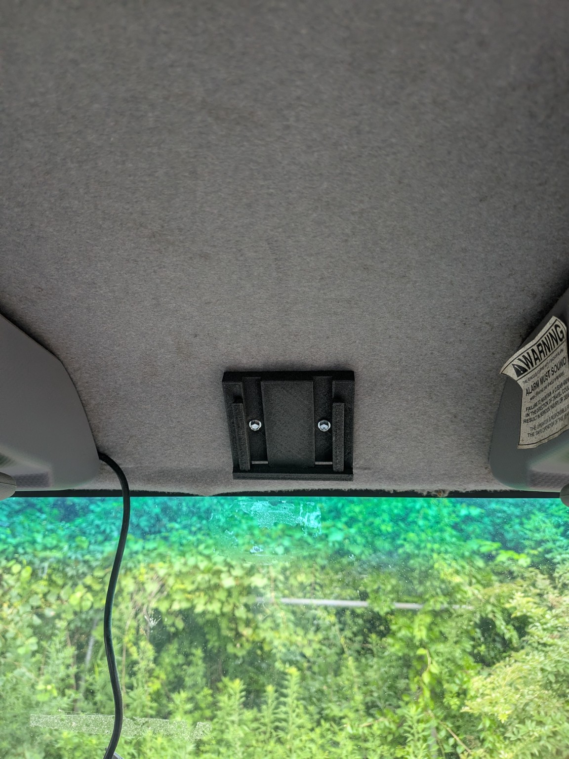Mounting plate fastened to the box-truck cab roof with two screws